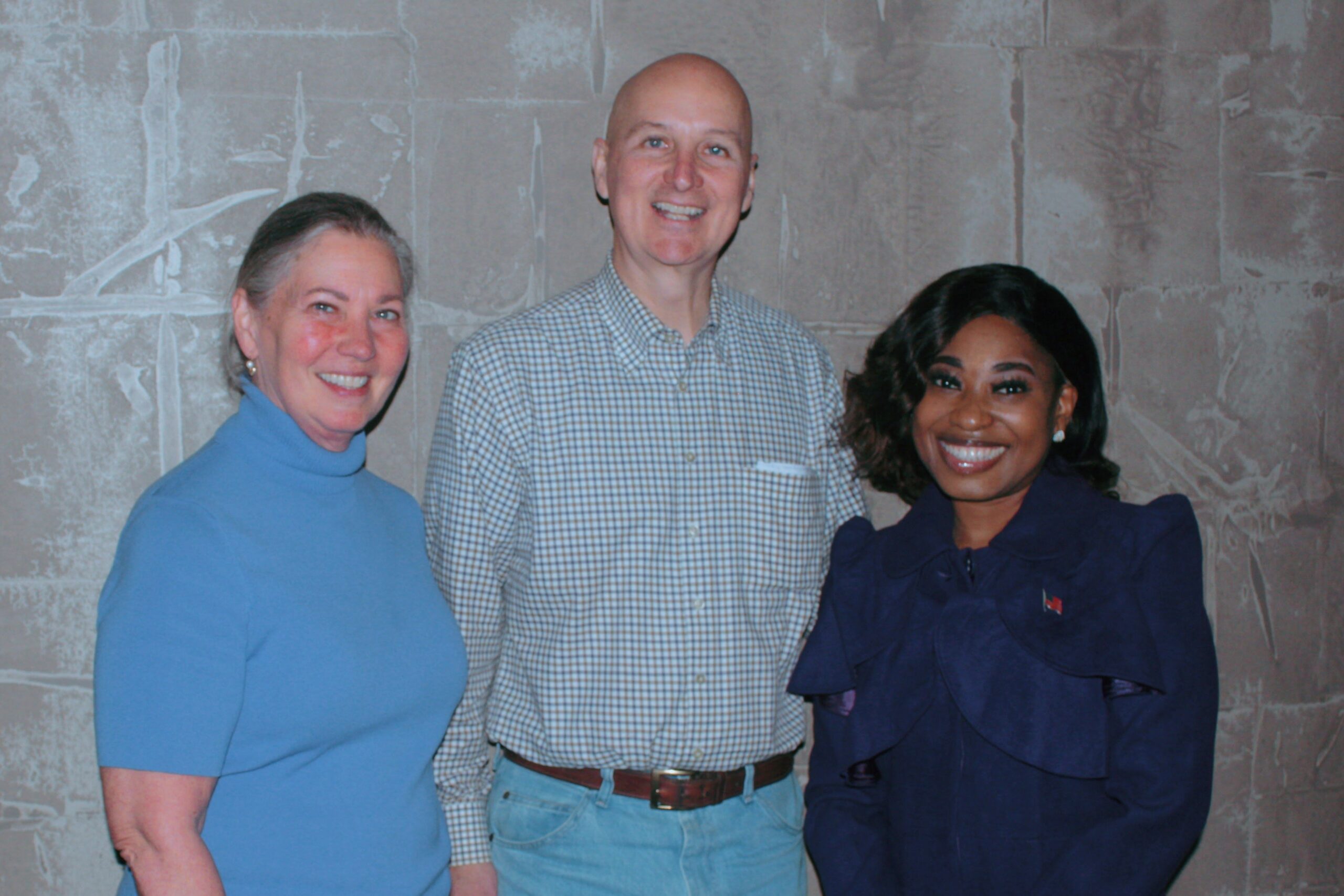 Wofai Samuel poses with Senator Pete Ricketts and One of GOP's Chairmen, Truemper at a Republican Rally.